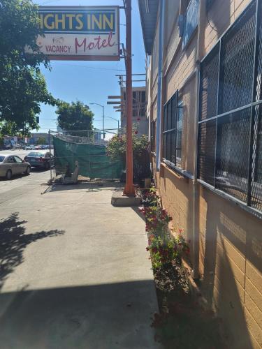 a sign on the side of a building next to a street at Nights Inn Motel in Oakland