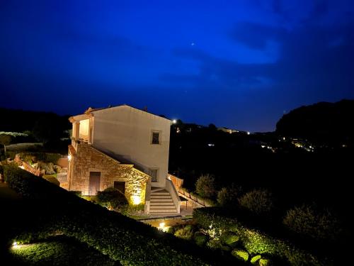 a house at night with lights on it at Antica Fonte Holiday Homes in San Pantaleo