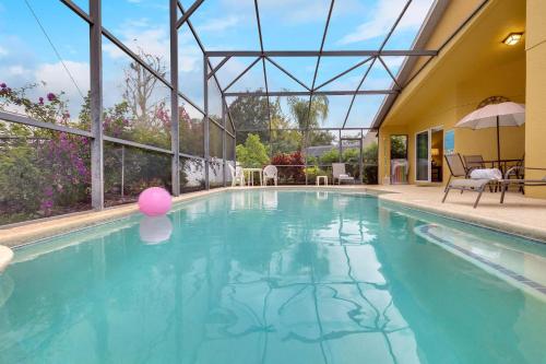 a swimming pool with a pink ball in the water at 4 bedrooms pool home gated resort of Veranda Palms in Kissimmee