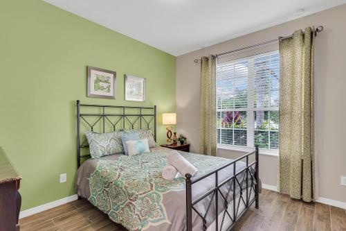 a bedroom with a bed and a window at 4 bedrooms pool home gated resort of Veranda Palms in Kissimmee
