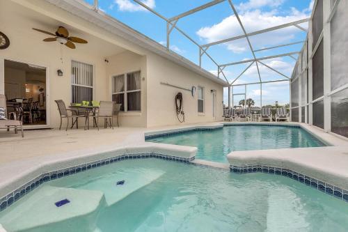 a swimming pool in the middle of a house at 4 bedrooms pool and spa home on golf course Fairways Estates in Kissimmee