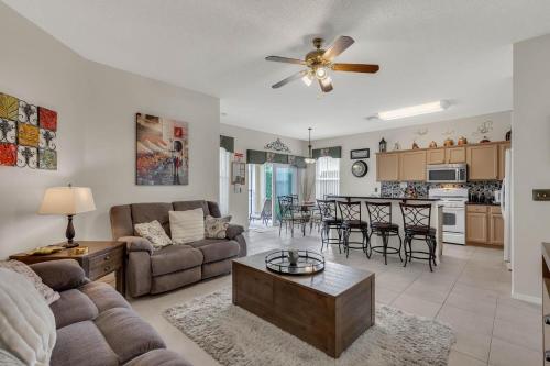 a living room with a couch and a table at 4 bedrooms pool and spa home on golf course Fairways Estates in Kissimmee