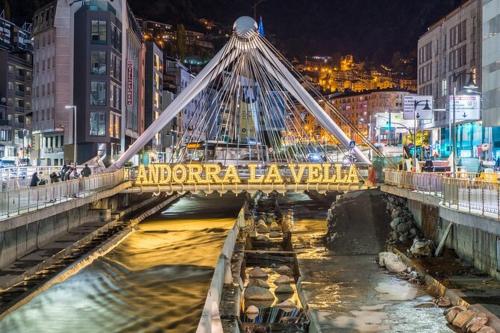 a bridge over a river in a city at night at ¡Más céntrico imposible! 6PAX+PK in Andorra la Vella
