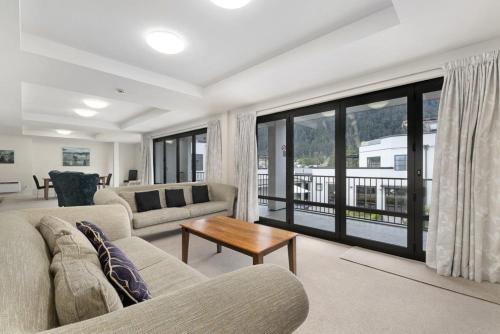 a living room with a couch and a table at The Glebe Apartments in Queenstown