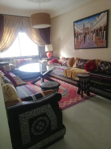 a living room with a couch and a table at شقة مفروشة in Agadir