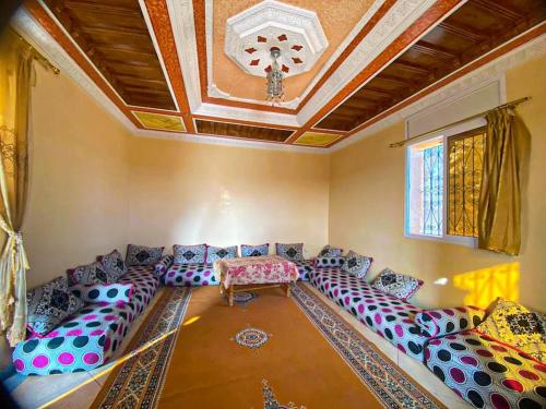 a living room with a large couch and a table at استمتع بالإقامة في فيلا أحلامك in El Khemis des Meskala