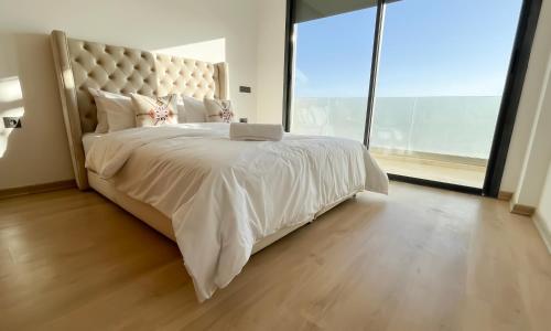 a bedroom with a large bed with a laptop on it at Cosy Bay appartement 4 - 5px in Agadir