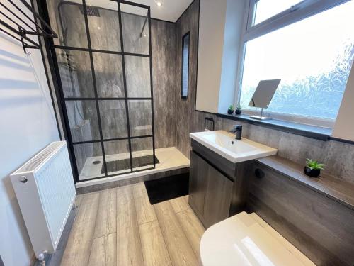 a bathroom with a toilet and a sink and a window at Seaviews Apartment 1, Whitley Bay Sea Front in Whitley Bay
