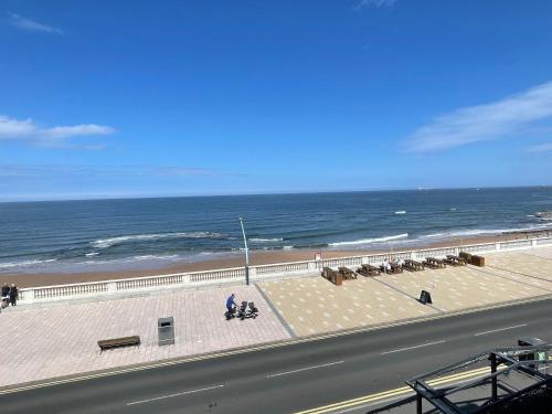a view of a beach with the ocean in the background at Seaviews Apartment 1, Whitley Bay Sea Front in Whitley Bay