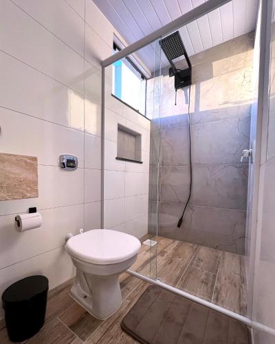 a bathroom with a toilet and a shower at Apartamento La Vie in São Joaquim