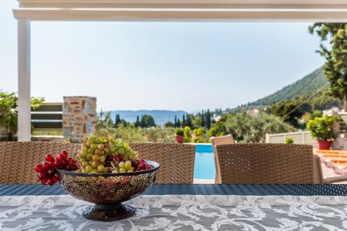 a bowl of fruit sitting on top of a table at Villa Ameli in Neo Klima