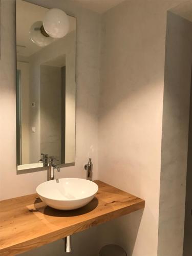 a bathroom with a white sink and a mirror at Corte LOIOL in Scorzarolo