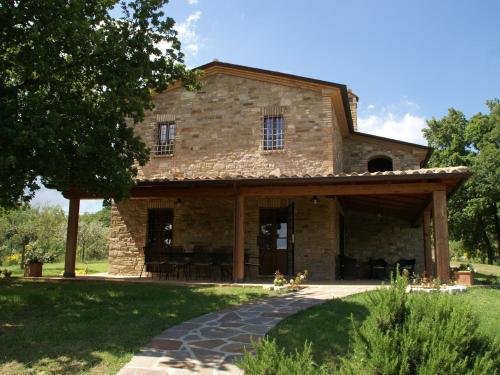 an old stone house with a pathway in front of it at Villa in Umbertide with Private Pool in Galera