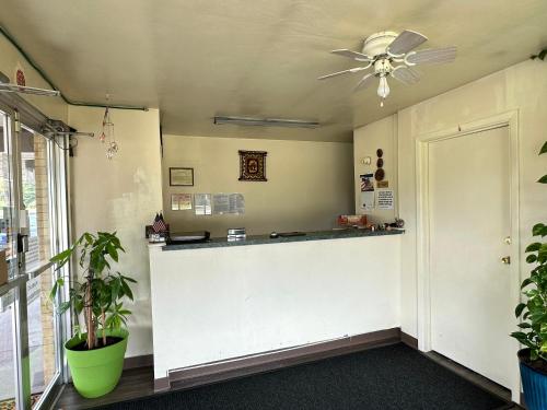 a lobby with a counter and a ceiling fan at Thruway Holiday Motel in Westfield