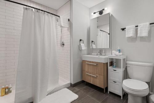 a bathroom with a toilet and a sink and a shower at Fully Furnished Apt Near Millenium Park- 29 in Chicago