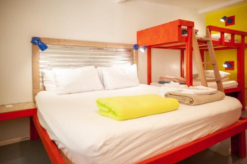 a bedroom with a bunk bed with a yellow pillow on it at Cloudcroft Hostel in Cloudcroft