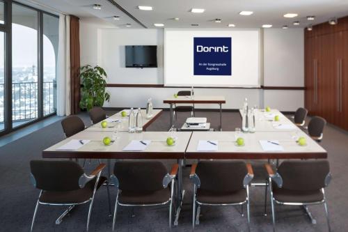 a conference room with a large table and chairs at Dorint An der Kongresshalle Augsburg in Augsburg