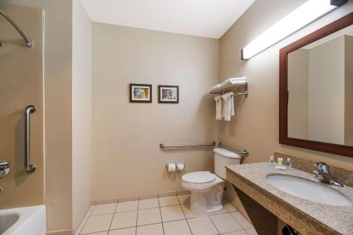 a bathroom with a toilet and a sink and a mirror at Comfort Inn & Suites Las Vegas - Nellis in Las Vegas