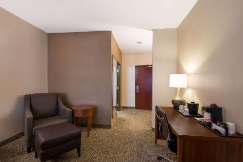 a hotel room with a desk and a chair at Comfort Inn & Suites Las Vegas - Nellis in Las Vegas