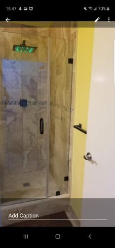 a shower with a glass door in a bathroom at Brighton View in Bridgetown