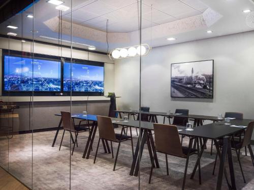 a conference room with tables and chairs and a large window at Radisson Blu Royal Viking Hotel, Stockholm in Stockholm