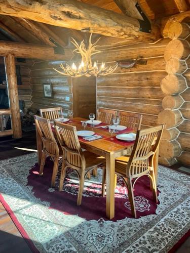 a wooden dining table and chairs in a cabin at John's Cabin in Somers