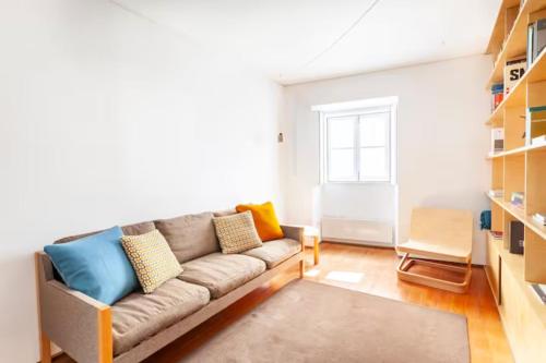a living room with a couch and a chair at SOBRE RIBAS 12 in Coimbra