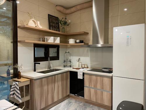 a kitchen with a sink and a refrigerator at 月月寓室 Luna INN 民宿 in Yilan City