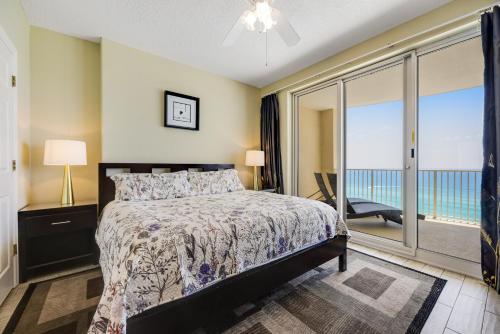 a bedroom with a bed and a large window at PARKING INCLUDED-Beachfront 2BD Ocean Villa! Gorgeous Amenities, Private Complex in Panama City Beach