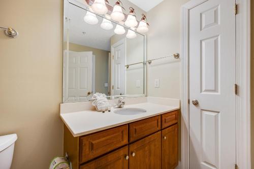 a bathroom with a sink and a mirror at PARKING INCLUDED-Beachfront 2BD Ocean Villa! Gorgeous Amenities, Private Complex in Panama City Beach