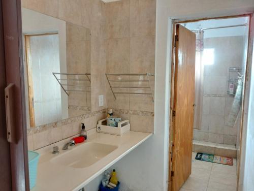 a bathroom with a sink and a mirror at Casa de campo los algarrobos 
