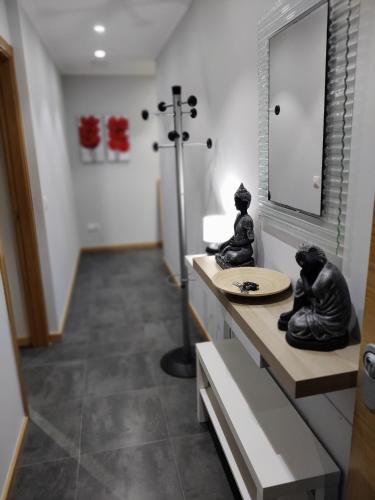 a bathroom with two statues sitting on a counter at Dena-Sol in Meaño
