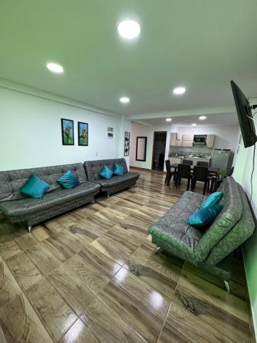 a living room with couches and a dining room at Apartamentos La Gloria Guatapé in Guatapé