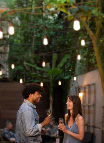 a man and a woman holding glasses of wine at Park Lane Suites & Inn in Portland