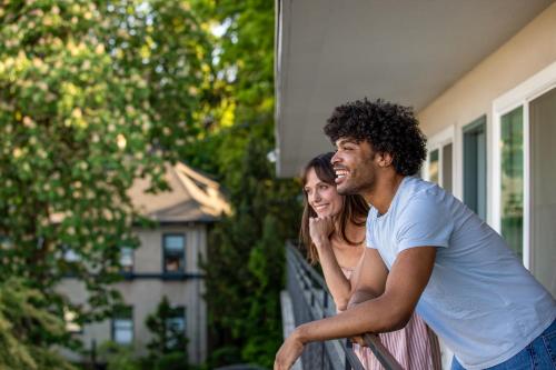 a man and a woman standing outside of a house at Park Lane Suites & Inn in Portland