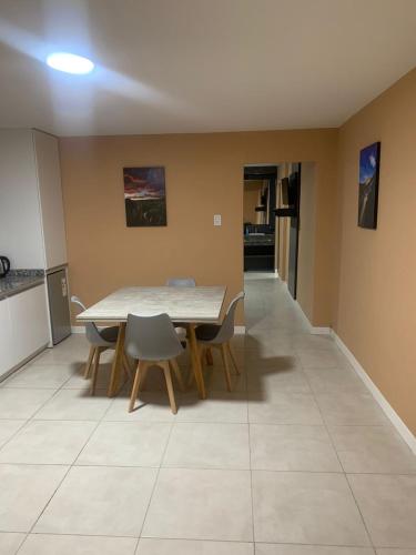 a dining room with a table and chairs at Departamento Kuyen in Malargüe