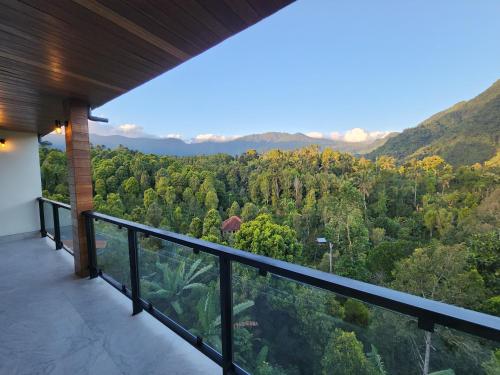 a balcony with a view of the forest at Taman Dari Villa in Sudaji