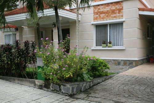 a house with some flowers in front of it at Vietnam Golf - Lake View Villas in Ho Chi Minh City