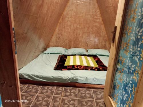 a small bed in a small room in a tent at Croods farm house in Kodaikānāl