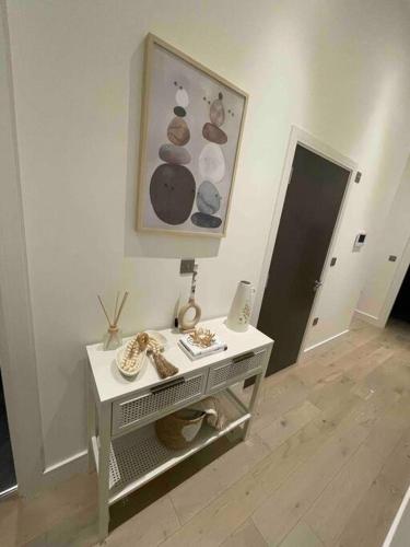 a room with a table with donuts on the wall at Luxury 2 bedroom Flat Sutton in Sutton