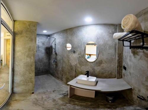 a bathroom with a sink and a shower at Silver County Hotel, Fuvahmulah - Maldives in Fuvahmulah