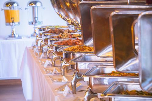 a row of buffet tables filled with food at Sea Breeze Hotel & Villa in Sihanoukville