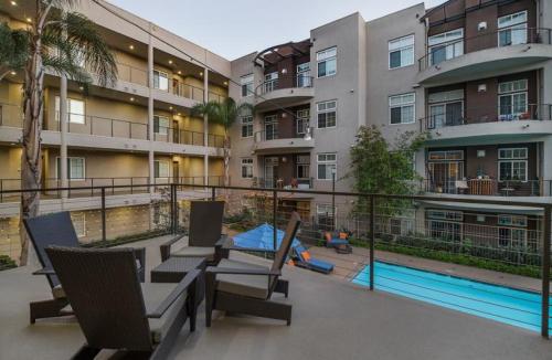 a apartment building with a swimming pool in front of it at Stunning 2bd with new furniture in Irvine