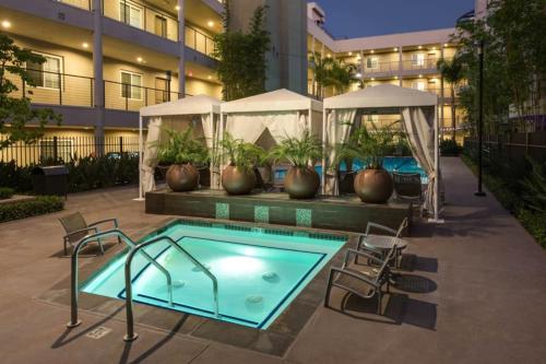 a swimming pool with chairs and a building at Stunning 2bd with new furniture in Irvine