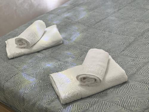 two folded towels on top of a bed at Playa malabata in Tangier