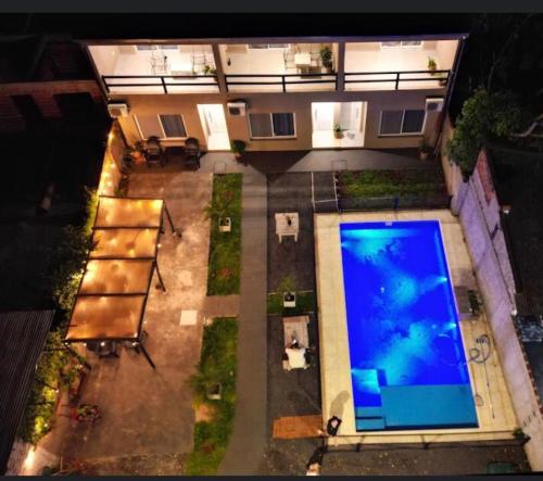 an overhead view of a swimming pool in front of a building at LOS LIRIOS in Puerto Iguazú