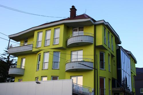 een geel gebouw met balkons erop bij Egnatia Apartments in Struga