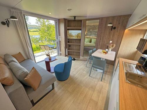 a living room with a couch and a table at tiny house am See, Neunburg vorm Wald in Neunburg vorm Wald