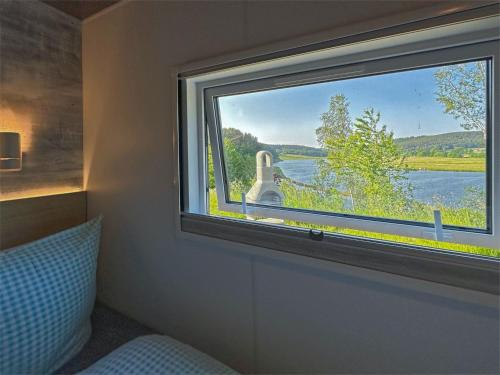 a bedroom with a window with a view of a river at tiny house am See, Neunburg vorm Wald in Neunburg vorm Wald