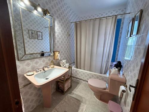 a bathroom with a sink and a toilet and a mirror at Spacious holiday home in almeria near beach in Almería